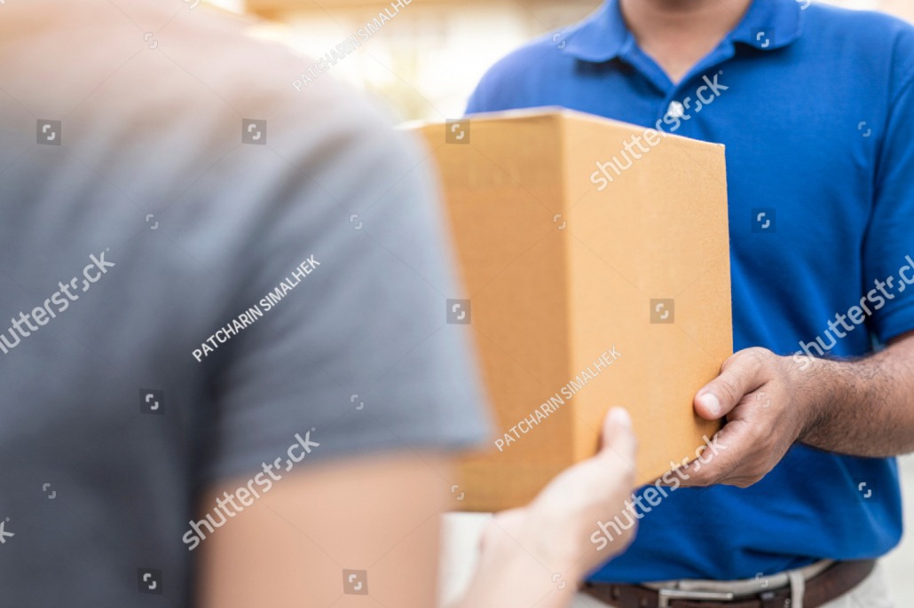 Womain receiving a package from a delivery person